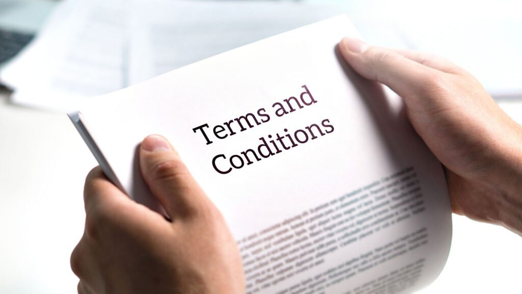 Close-up of person holding 'Terms and Conditions' document