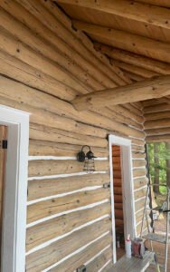 Log cabin exterior with rustic design and outdoor lighting