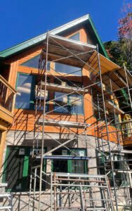Scaffolding on a modern wooden house under renovation