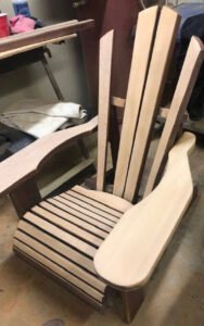 Handcrafted wooden Adirondack chair in a workshop