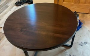 Round wooden table with dark finish for recent work project