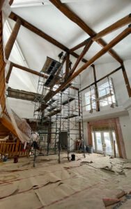 Interior renovation with scaffolding and wooden beams in progress