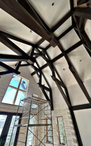 Modern timber frame construction in progress with scaffold inside a tall building