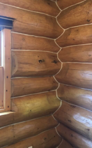 Rustic wooden log cabin interior corner with window