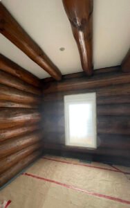 Renovated log cabin interior with exposed wooden beams