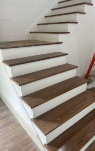 Modern wooden staircase with white risers in recent renovation work