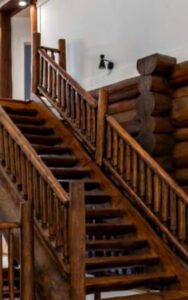 Rustic wooden staircase in a log cabin interior