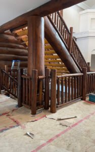 Rustic wooden staircase under construction in a modern interior