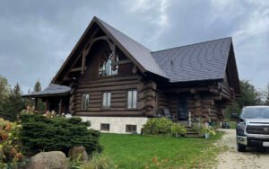 Rustic log cabin with a modern design against a cloudy sky