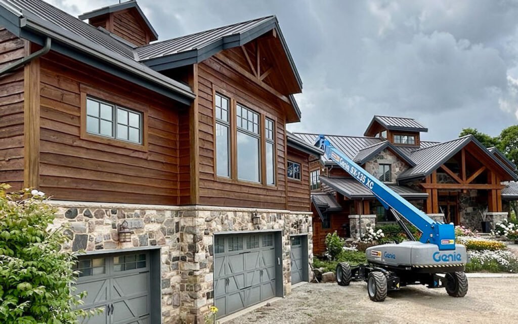 Elevated construction lift at rustic stone and wood houses