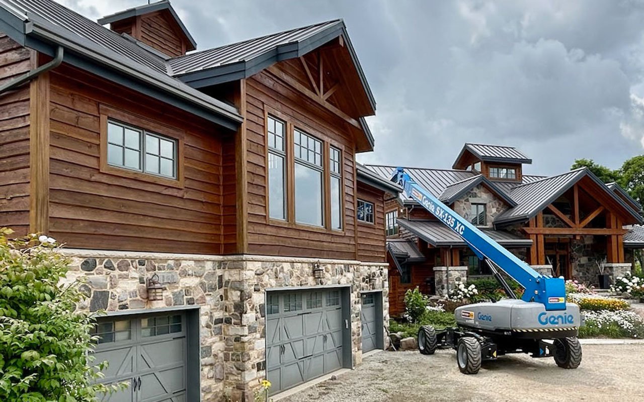 Elevated construction lift at rustic stone and wood houses