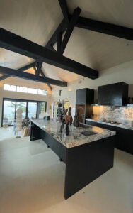 Modern kitchen with marble island and black cabinets