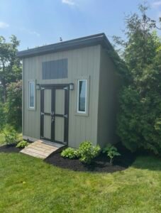 Modern garden shed with sloped roof on landscaped lawn