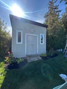 Backyard garden shed with double doors and decorative clock