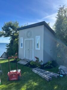 Modern wooden shed by the lake with circular window